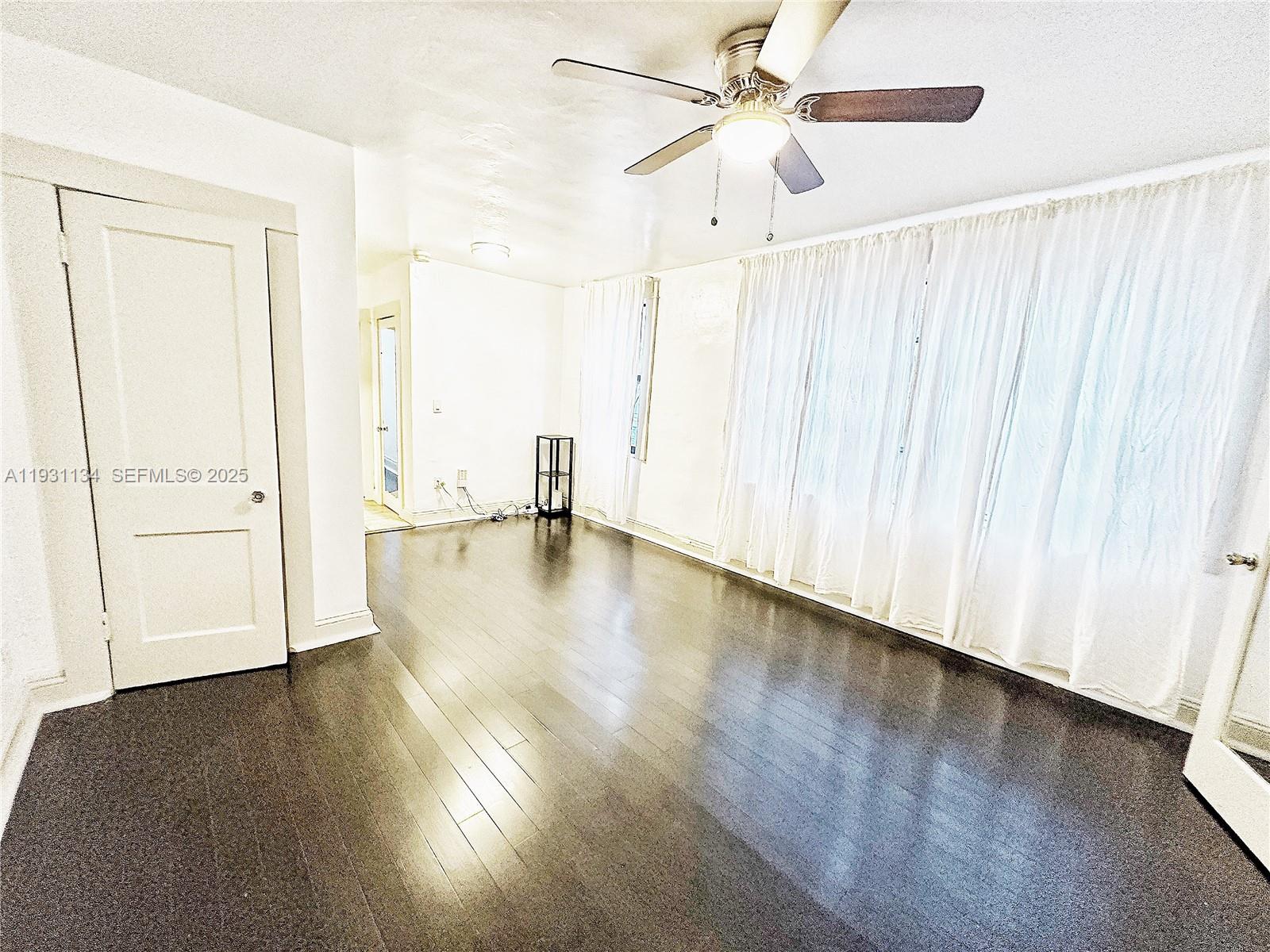 2153 Southwest 14th Terrace, Unit 1 Miami, FL 33145 - Photo 7 of 17 a view of empty room with wooden floor and fan