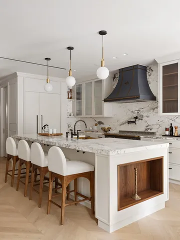 a kitchen with stainless steel appliances kitchen island granite countertop a table chairs sink and white cabinets