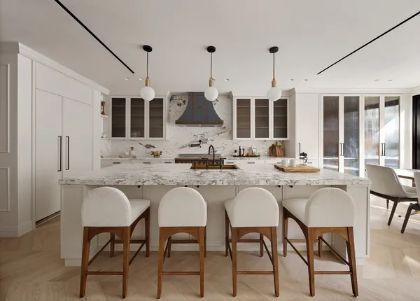 a kitchen with a sink chairs and white cabinets
