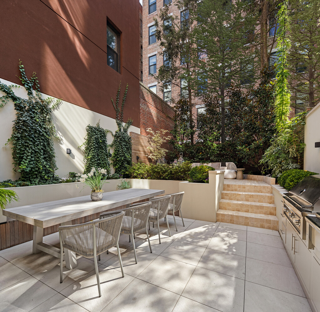 34 West 12th Street Manhattan, NY 10011 - Photo 15 of 53 a view of patio with table and chairs under an umbrella with large trees