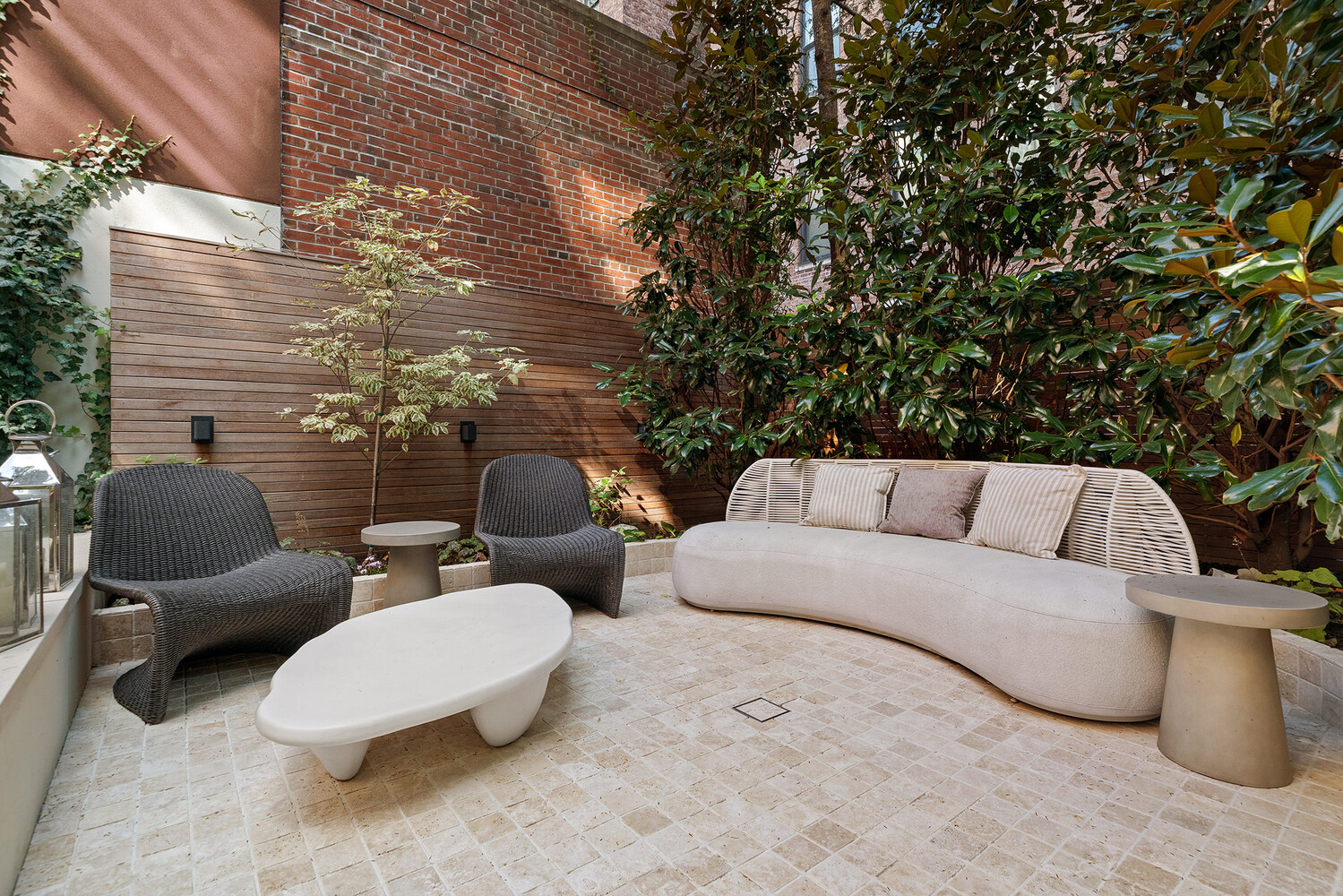 34 West 12th Street Manhattan, NY 10011 - Photo 18 of 53 a view of a patio with couches and chairs under an umbrella