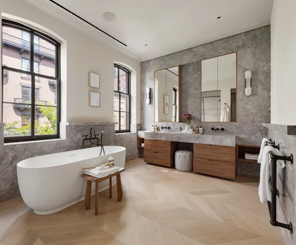 a spacious bathroom with a bathtub sink and mirror