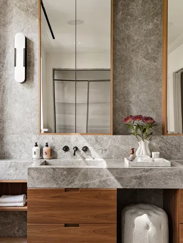 a bathroom with a granite countertop sink and a mirror