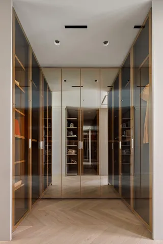 a view of a hallway with wooden shelves