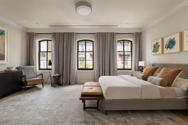 a bedroom with a bed and a couch