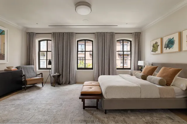 a bedroom with a bed and a couch