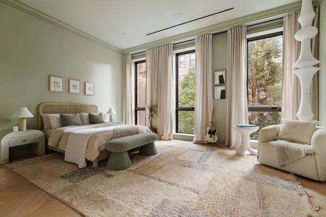 a spacious bedroom with a bed and a couch