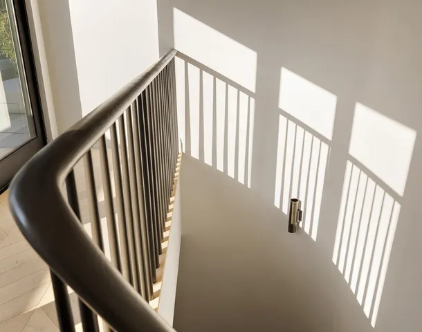 a roof deck with couches and potted plants