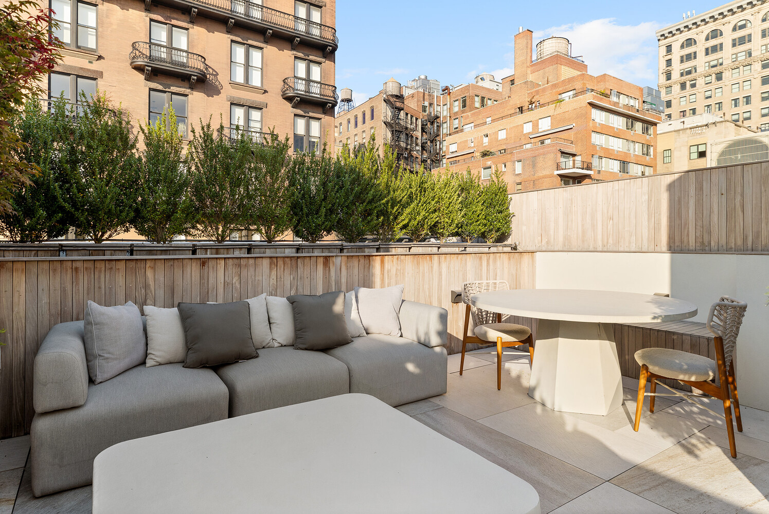 34 West 12th Street Manhattan, NY 10011 - Photo 47 of 53 a roof deck with couches and potted plants