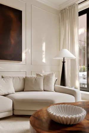 a living room with furniture a fireplace and a chandelier