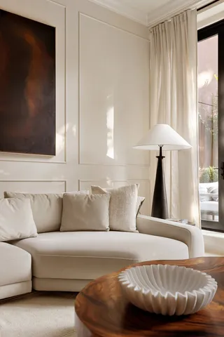 a living room with furniture a fireplace and a chandelier