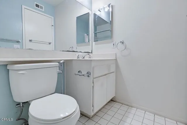 a bathroom with a sink toilet and mirror