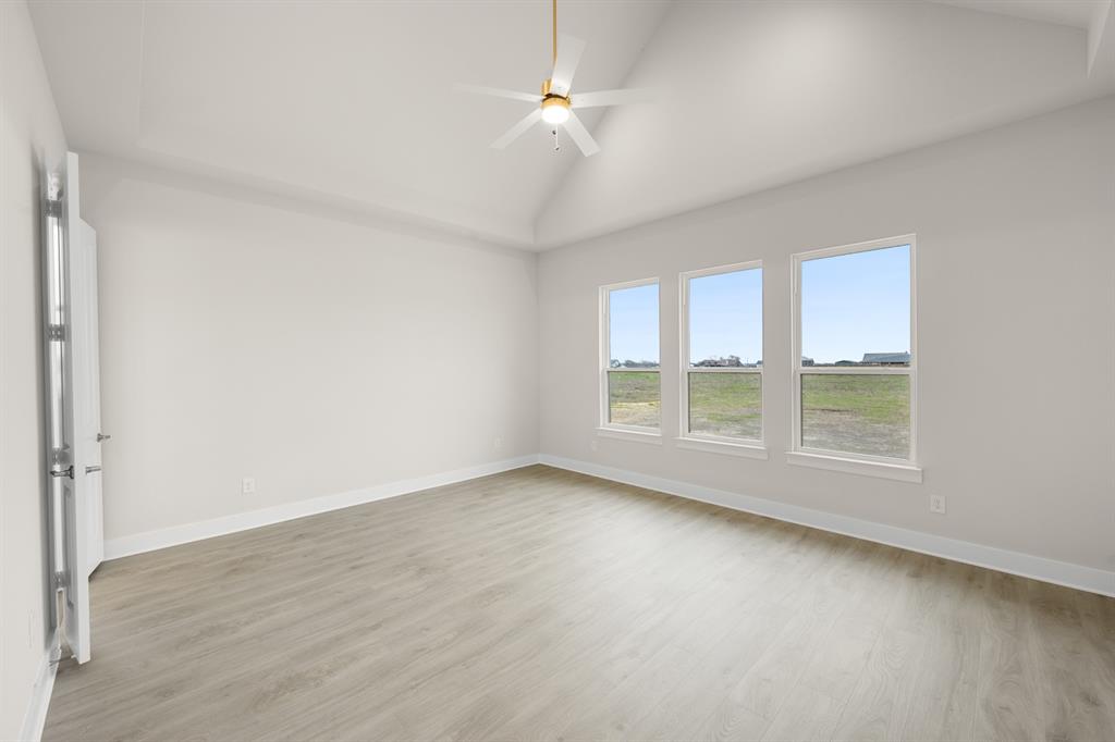 151 Talpin Lane Venus, TX 76084 - Photo 13 of 28 wooden floor in an empty room with a window