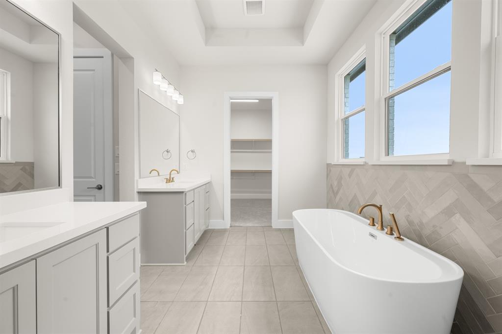 151 Talpin Lane Venus, TX 76084 - Photo 15 of 28 a spacious bathroom with a bathtub sink and mirror