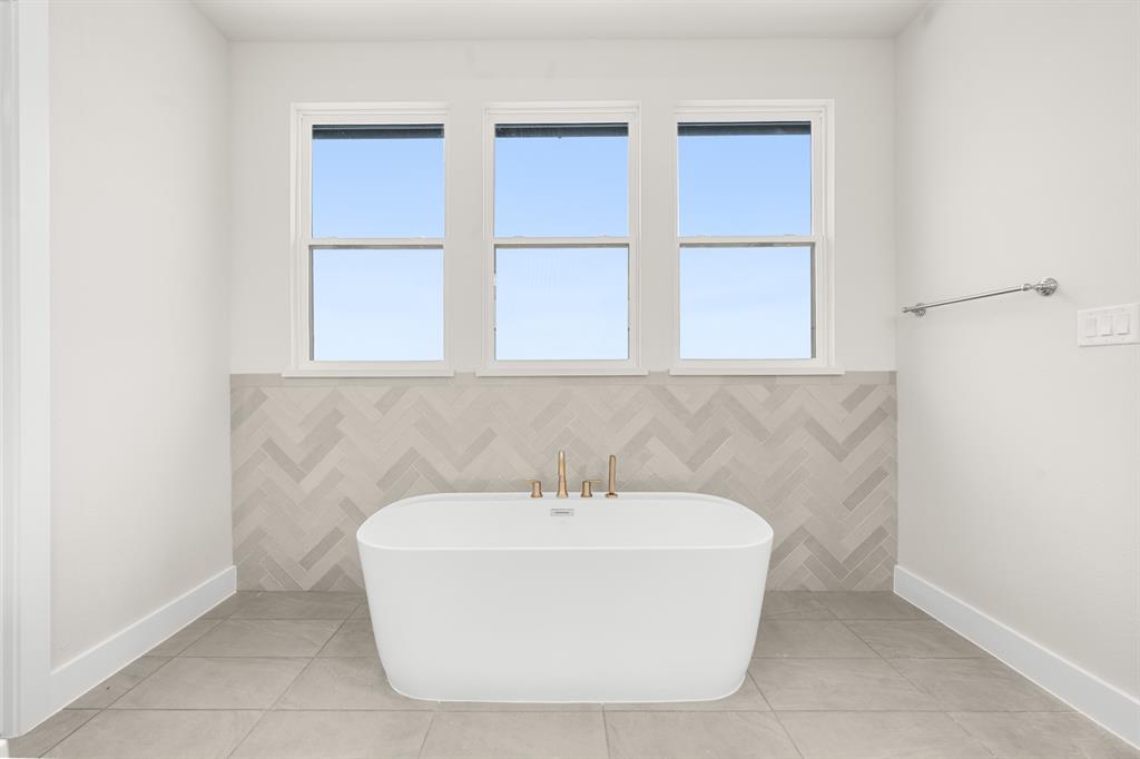 151 Talpin Lane Venus, TX 76084 - Photo 16 of 28 a white bath tub sitting in a bathroom
