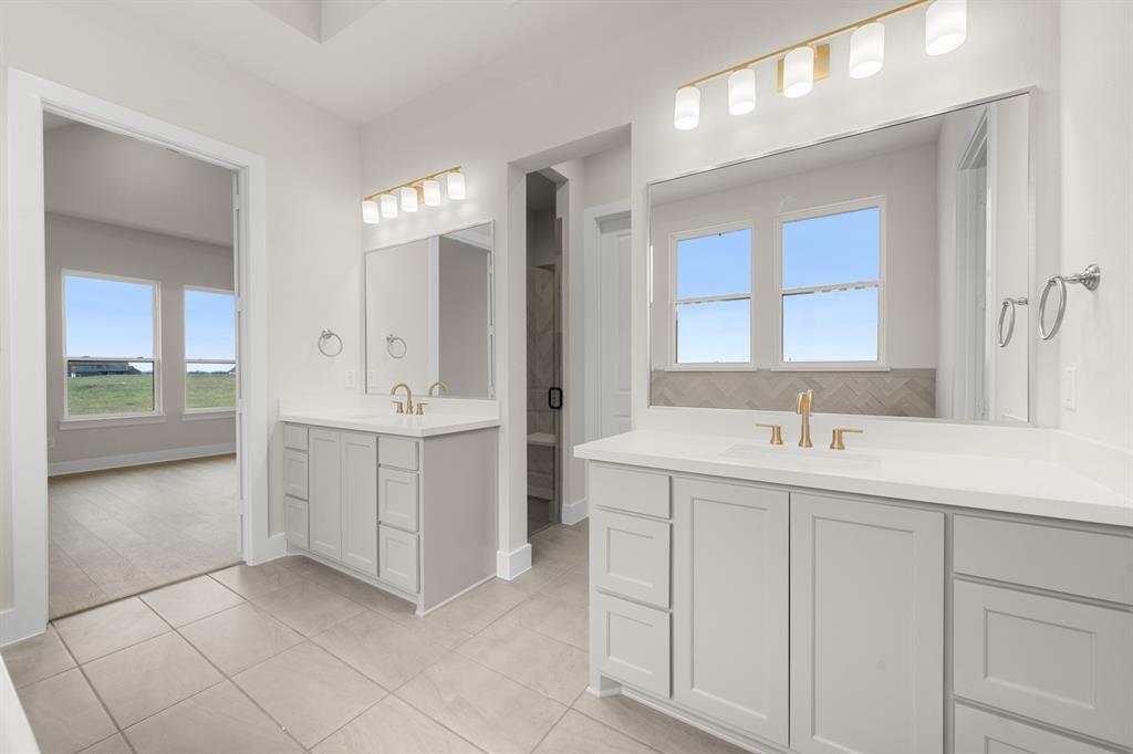 151 Talpin Lane Venus, TX 76084 - Photo 17 of 28 a bathroom with a sink and a mirror