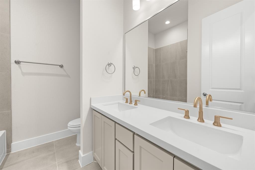 151 Talpin Lane Venus, TX 76084 - Photo 23 of 28 a bathroom with a sink a toilet and a large mirror