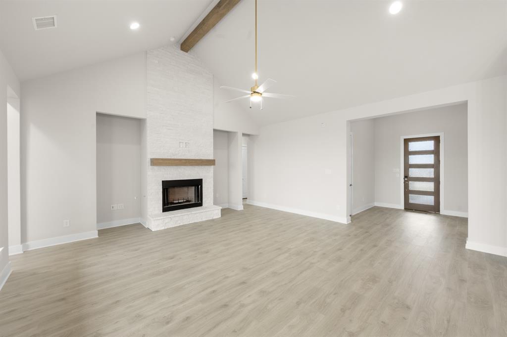 151 Talpin Lane Venus, TX 76084 - Photo 5 of 28 a view of an empty room with a fireplace and a window
