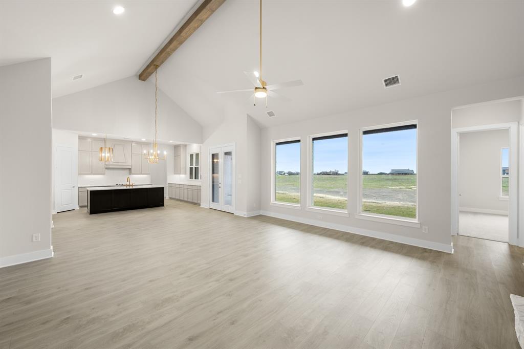 151 Talpin Lane Venus, TX 76084 - Photo 6 of 28 a view of an empty room with a window and kitchen view
