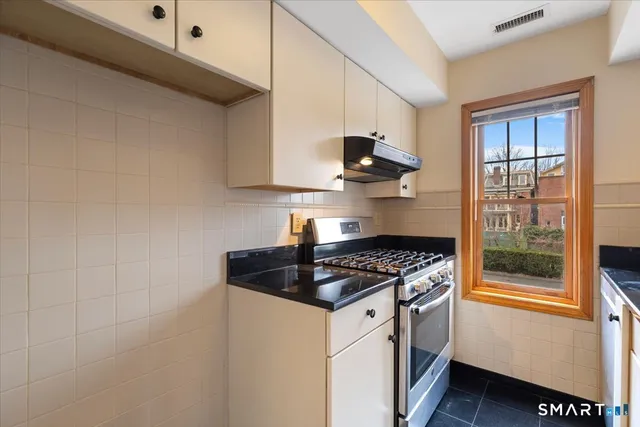 a kitchen with stainless steel appliances granite countertop a stove and a sink