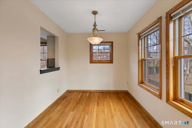 a view of a room with a window and wooden floor