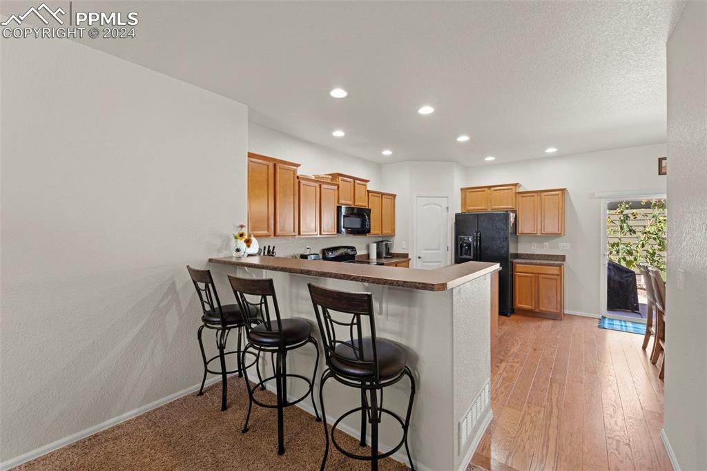 6310 Pilgrimage Road Colorado Springs, CO 80925 - Photo 11 of 31 a kitchen with a table and chairs in it