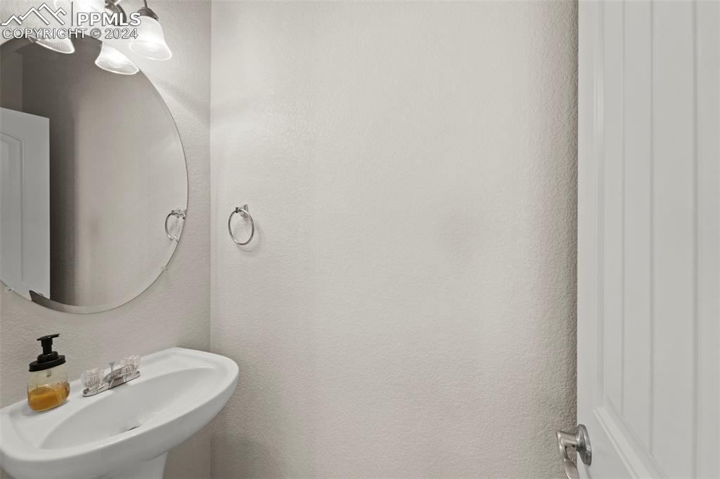 6310 Pilgrimage Road Colorado Springs, CO 80925 - Photo 18 of 31 a bathroom with a sink and a mirror