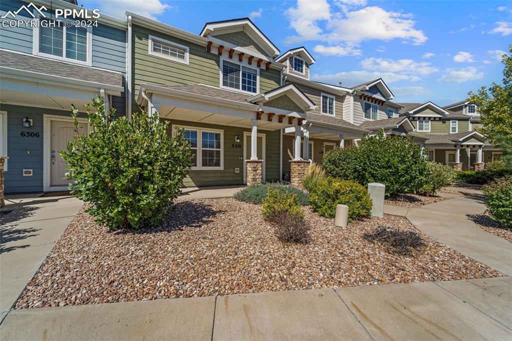 6310 Pilgrimage Road Colorado Springs, CO 80925 - Photo 2 of 31 front view of a house with a small yard
