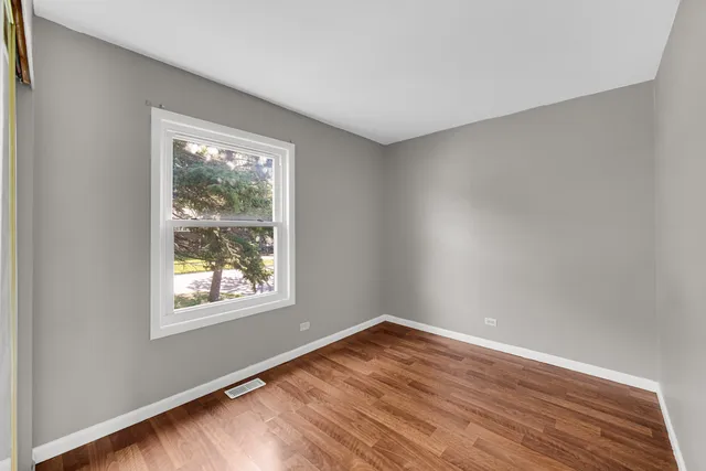 a bathroom with a granite countertop toilet sink and mirror