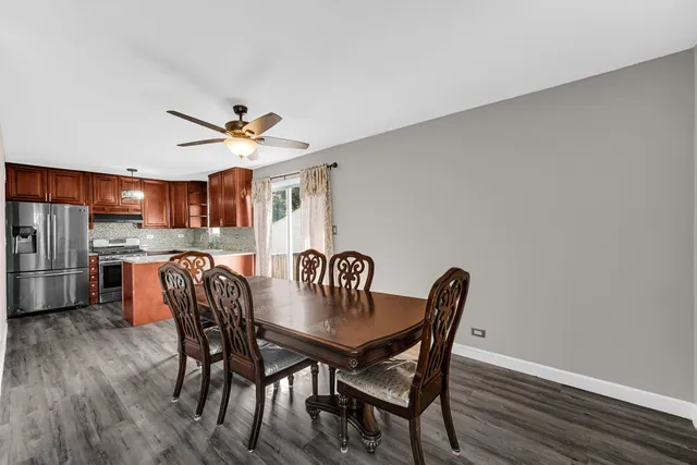 a view of a dining room with furniture and window