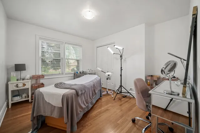 a bedroom with a bed a desk and chair