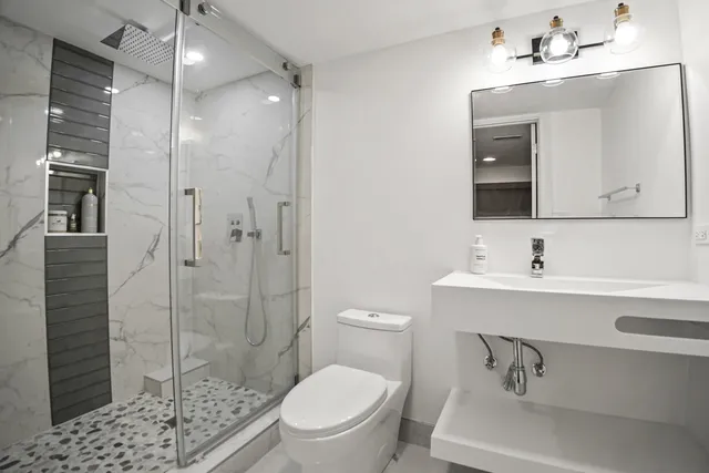 a bathroom with a sink toilet and shower