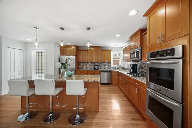 a large kitchen with lots of counter space and stainless steel appliances