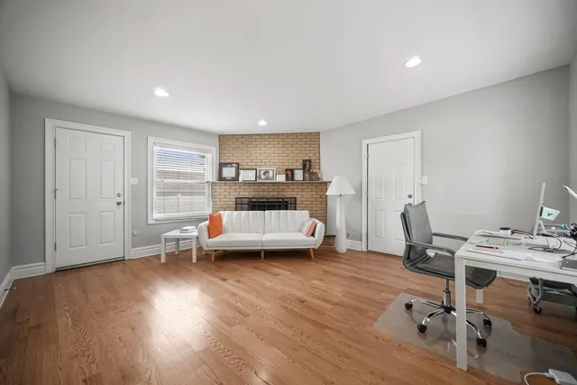 a view of a room with wooden floor and lounge chair