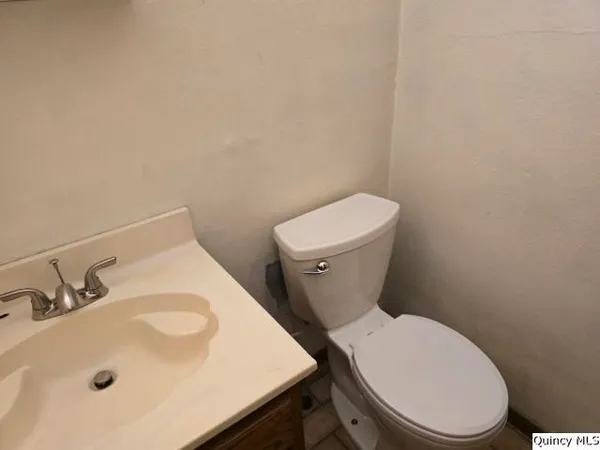 a white toilet sitting next to a bathroom sink