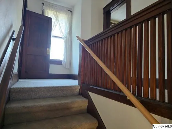 a stairs with wooden floor in a corridor