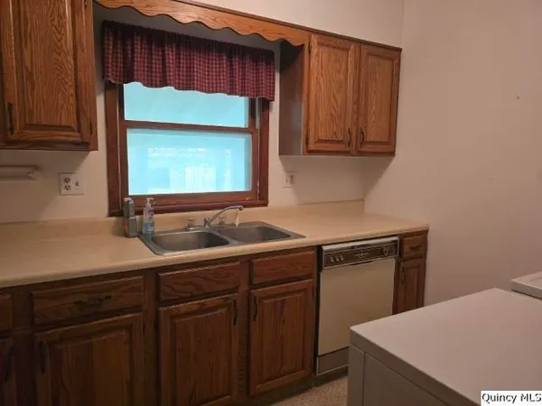 a kitchen with a sink and cabinets