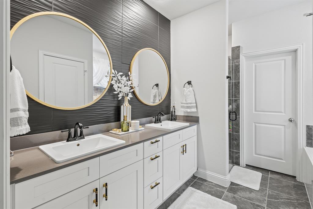 4220 Calla Drive Forney, TX 75126 - Photo 13 of 30 a bathroom with 2 sink and a mirror