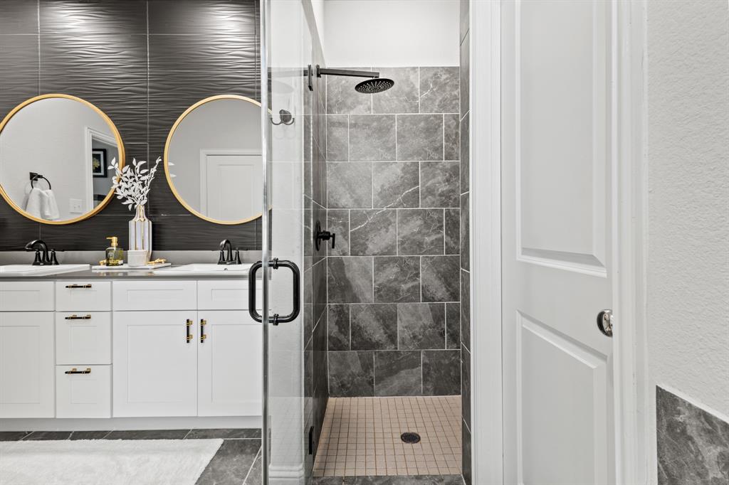 4220 Calla Drive Forney, TX 75126 - Photo 15 of 30 a bathroom with a double vanity sink mirror and shower