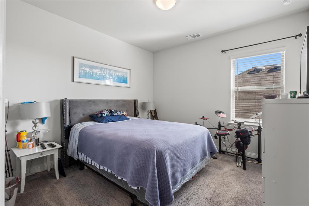 4220 Calla Drive Forney, TX 75126 - Photo 16 of 30 a bedroom with a bed and a table in it