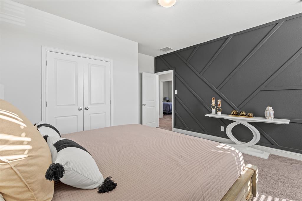 4220 Calla Drive Forney, TX 75126 - Photo 19 of 30 a bedroom with a bed and cabinets