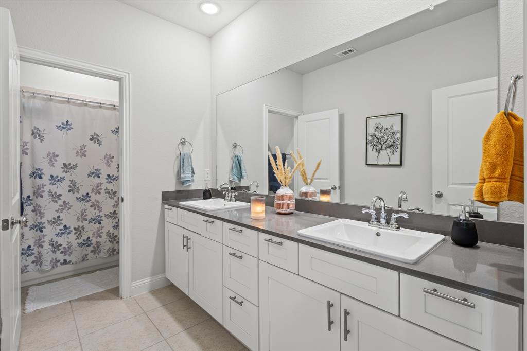 4220 Calla Drive Forney, TX 75126 - Photo 20 of 30 a bathroom with a double vanity sink mirror and double