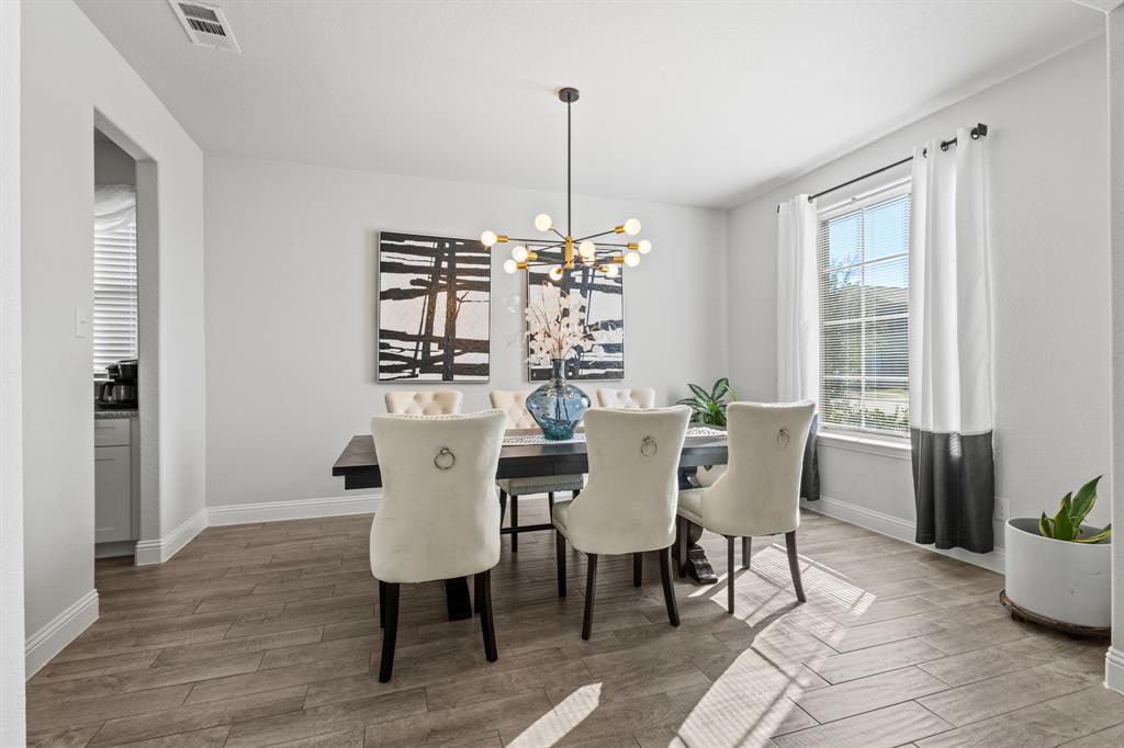 4220 Calla Drive Forney, TX 75126 - Photo 2 of 30 a view of a dining room with furniture window and wooden floor