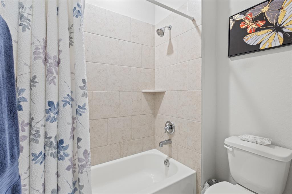 4220 Calla Drive Forney, TX 75126 - Photo 21 of 30 a bathroom with a toilet and a shower curtain
