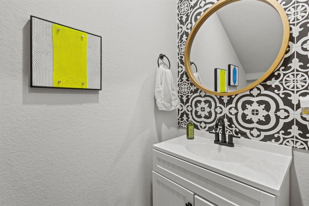 4220 Calla Drive Forney, TX 75126 - Photo 23 of 30 a bathroom with a sink and a mirror