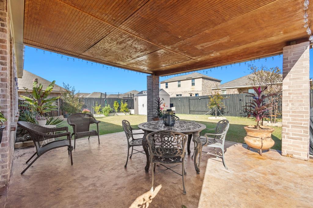 4220 Calla Drive Forney, TX 75126 - Photo 25 of 30 a view of a patio with a table and chairs under an umbrella