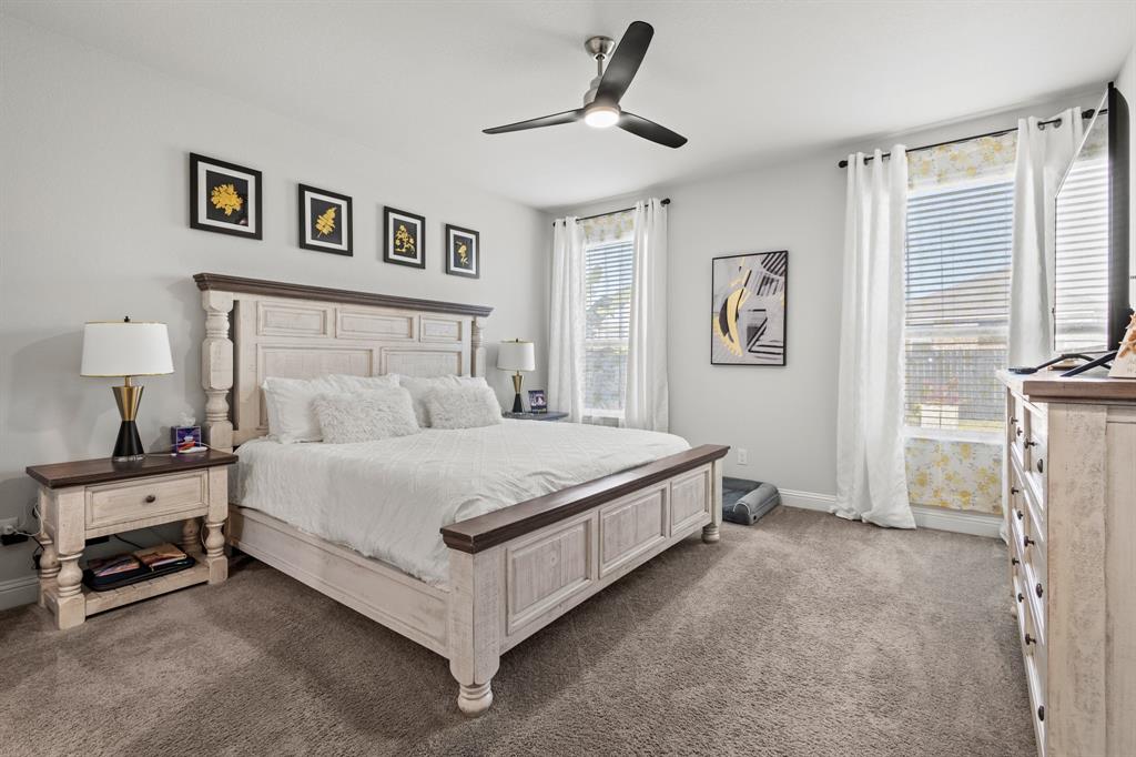 4220 Calla Drive Forney, TX 75126 - Photo 10 of 30 a bedroom with a bed and a chandelier