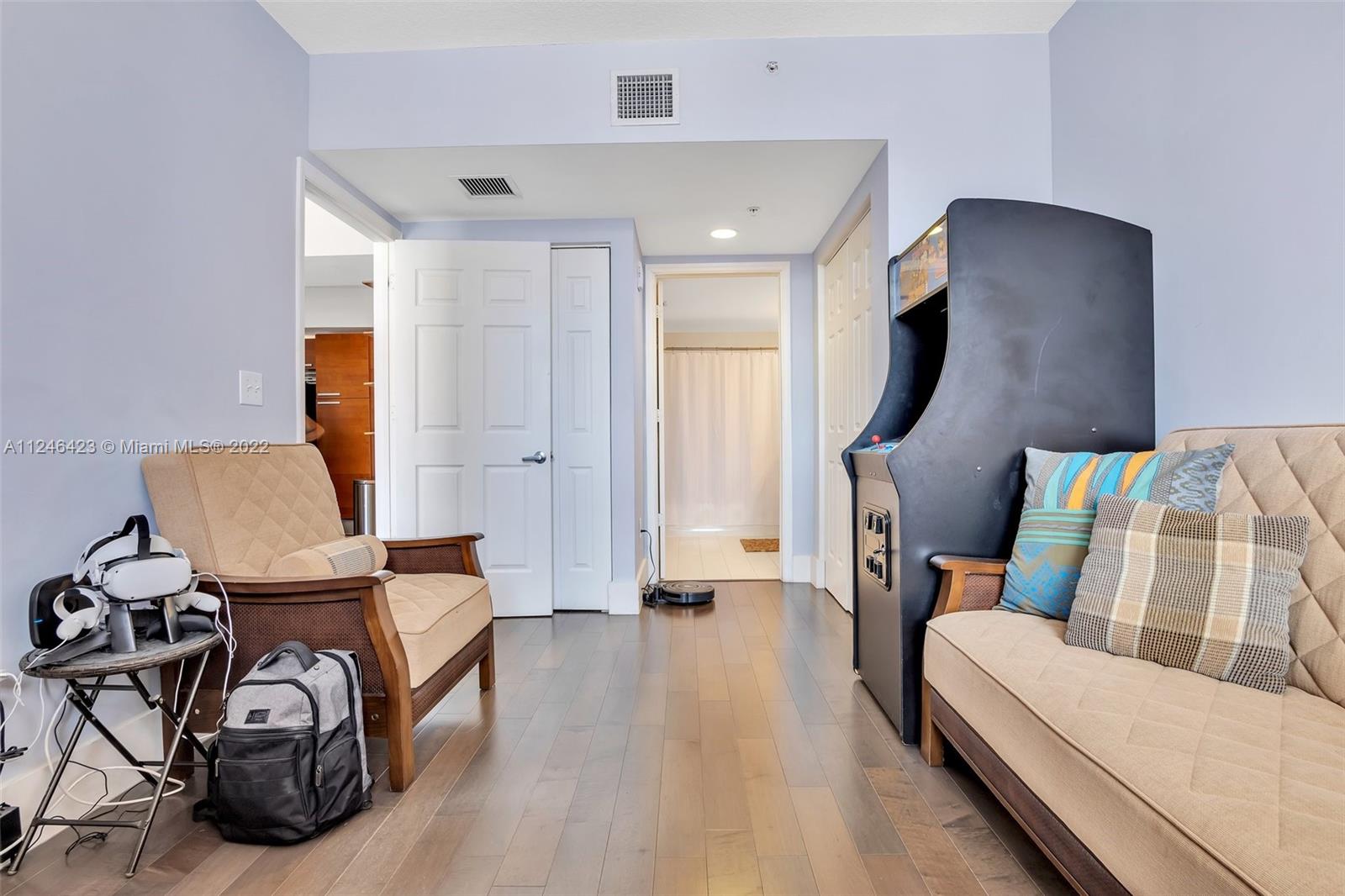 2030 Douglas Road, Unit 817 Coral Gables, FL 33134 - Photo 17 of 28 a bedroom with furniture and wooden floor