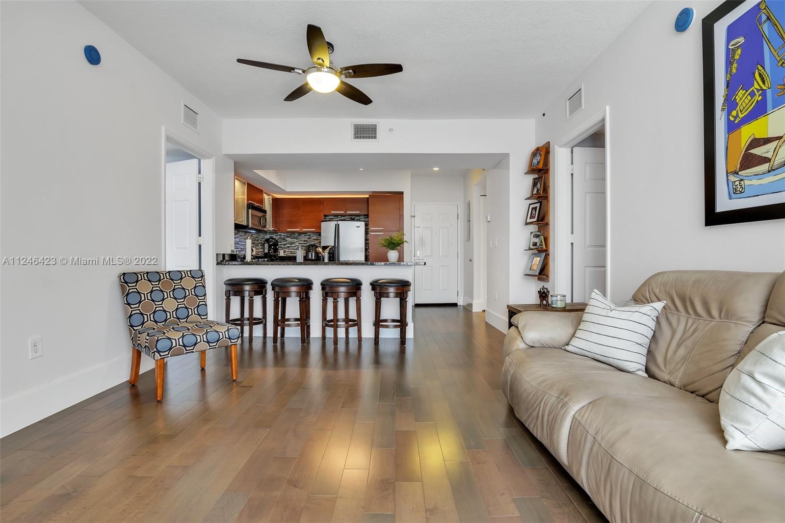 2030 Douglas Road, Unit 817 Coral Gables, FL 33134 - Photo 5 of 28 a living room with furniture and a wooden floor