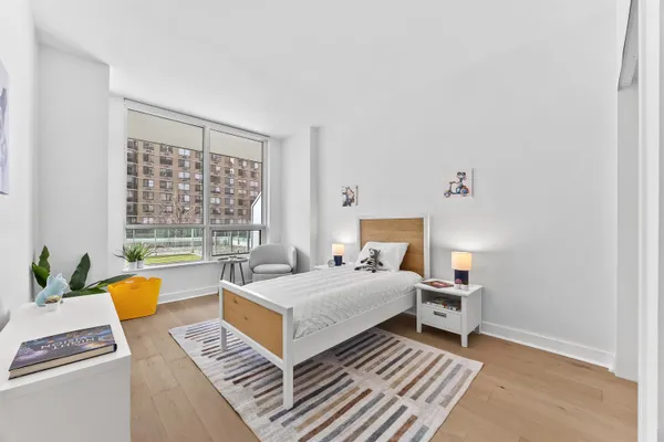 a bedroom with a bed and a window